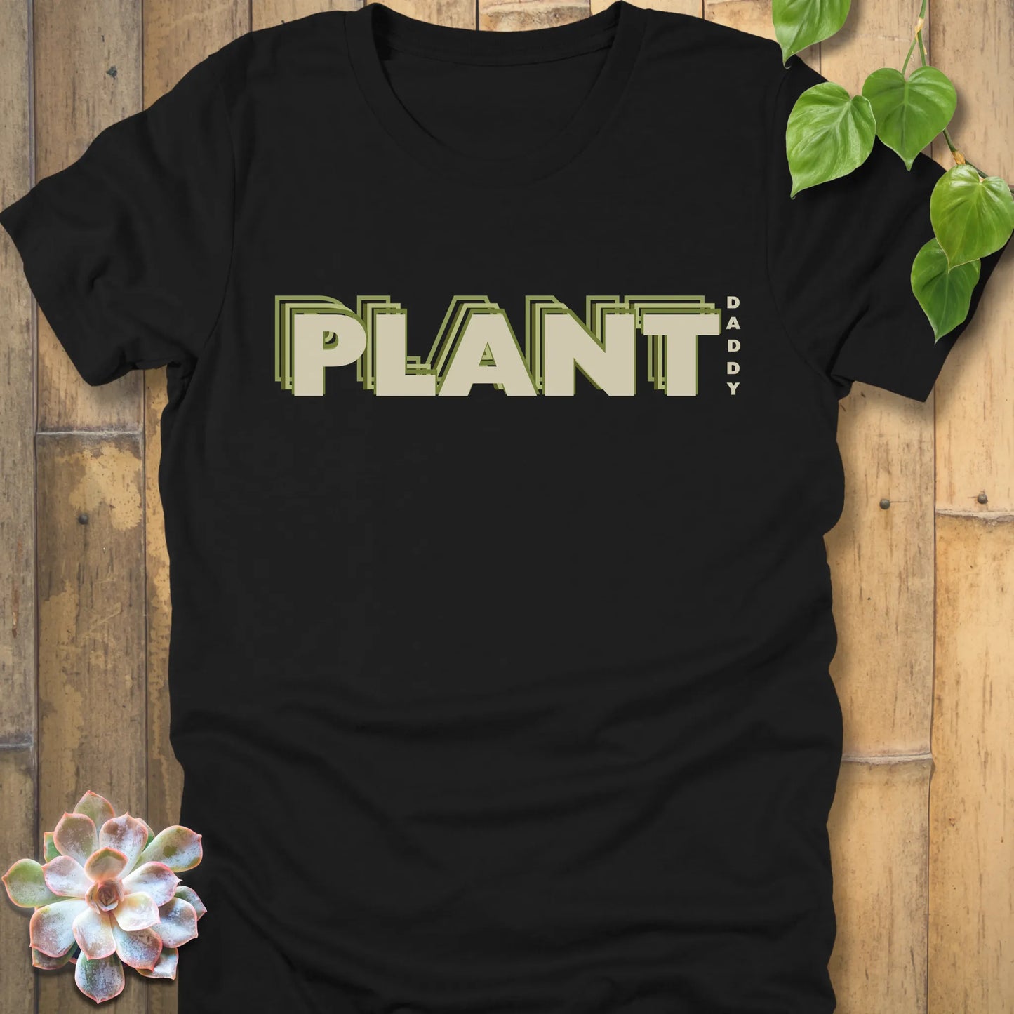 Black t-shirt featuring the design Plant Daddy printed in bold letters, soft cotton botanical shirt.