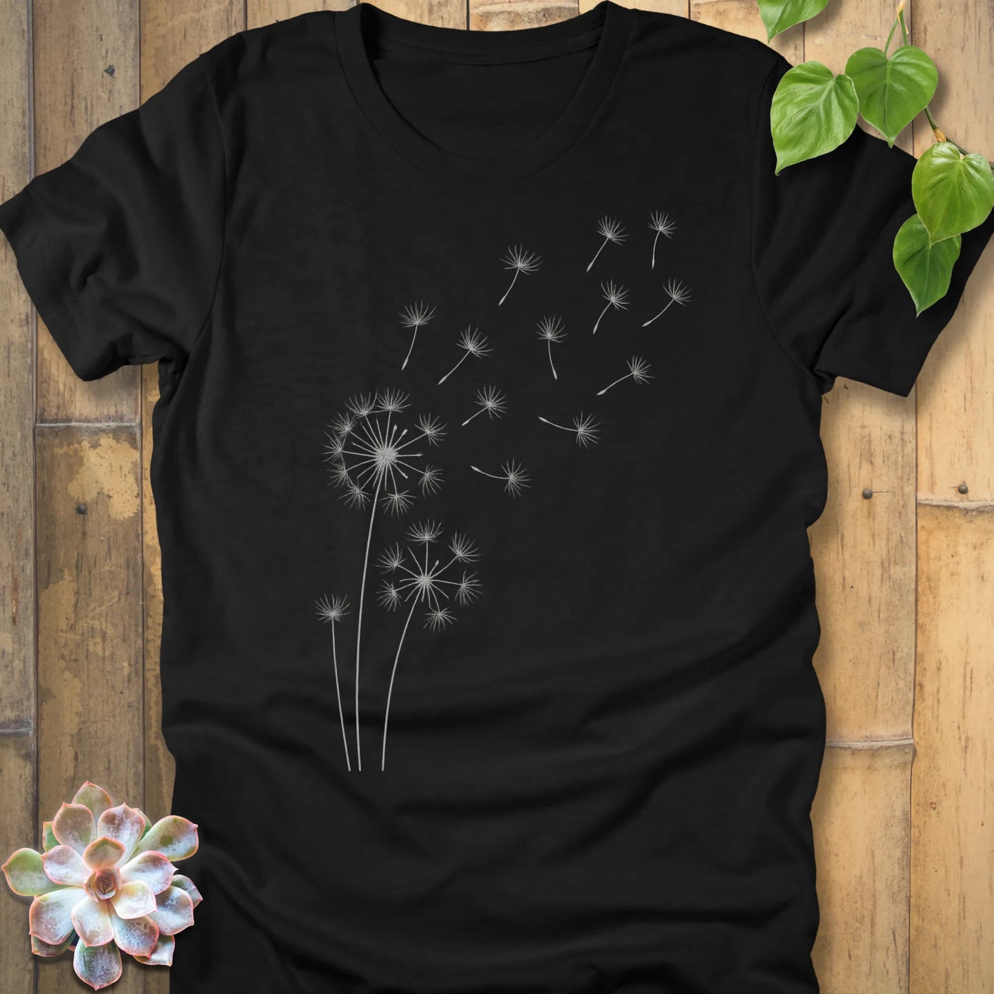 Black t-shirt featuring the design Wishes Come True printed in floral graphic tee.