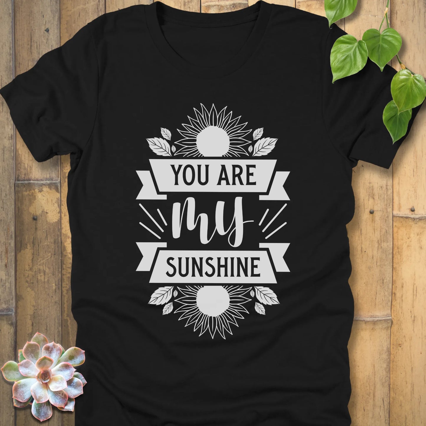 Black t-shirt featuring the design You are my sunshine printed in bold letters with a sunflower graphic