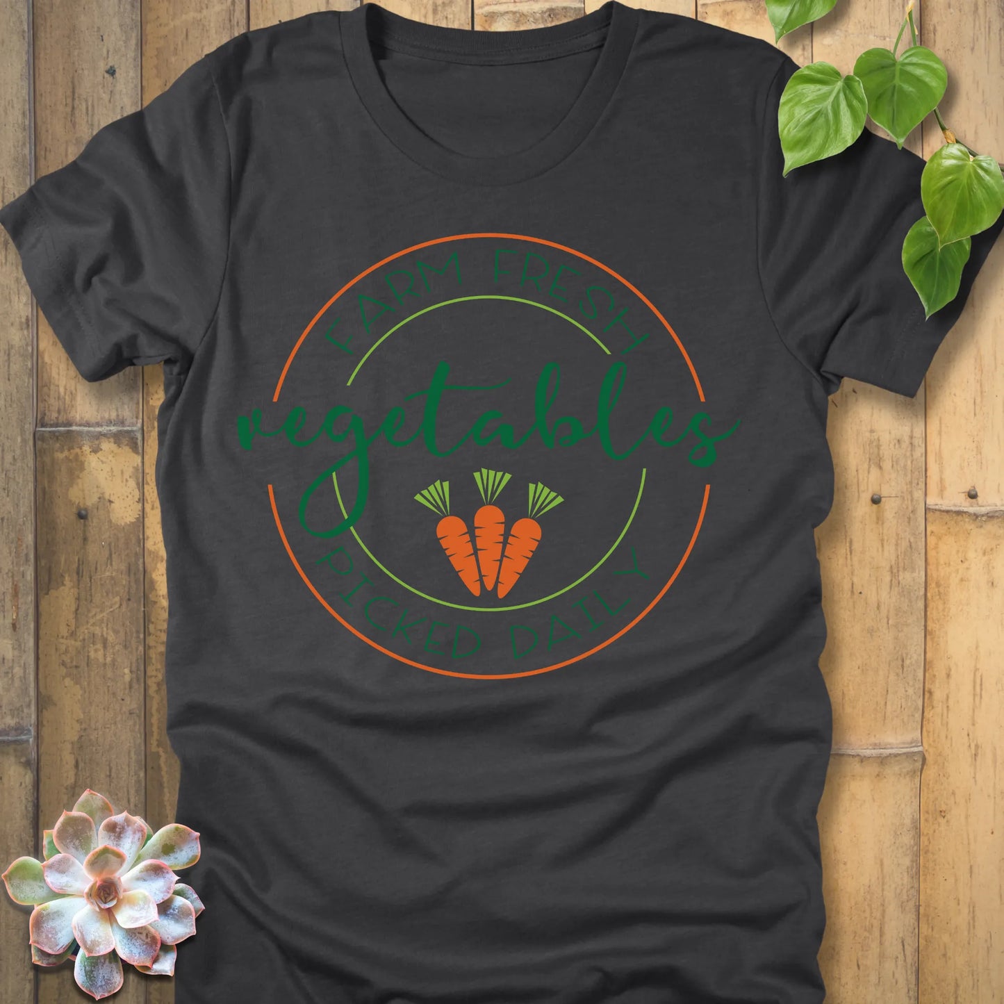 Dark Grey Heather t-shirt featuring the design Fresh Vegetables printed in green letters and some carrots, organic vegetable lover shirt.