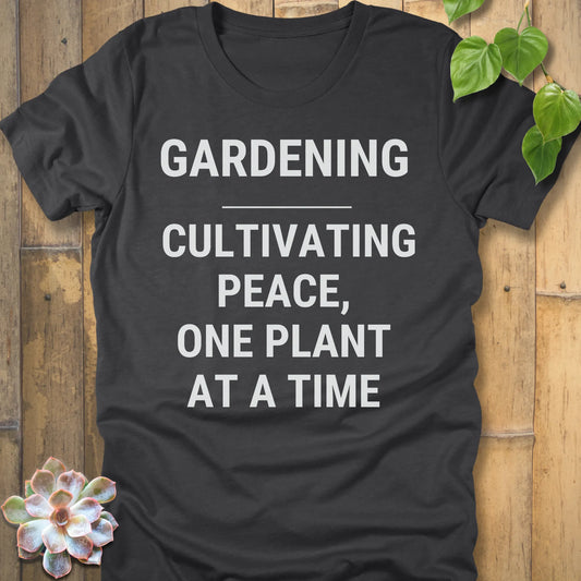 Dark Grey Heather t-shirt featuring the design Gardening Cultivating Peace, One Plant At A Time printed in bold white letters, funny gardening shirt.