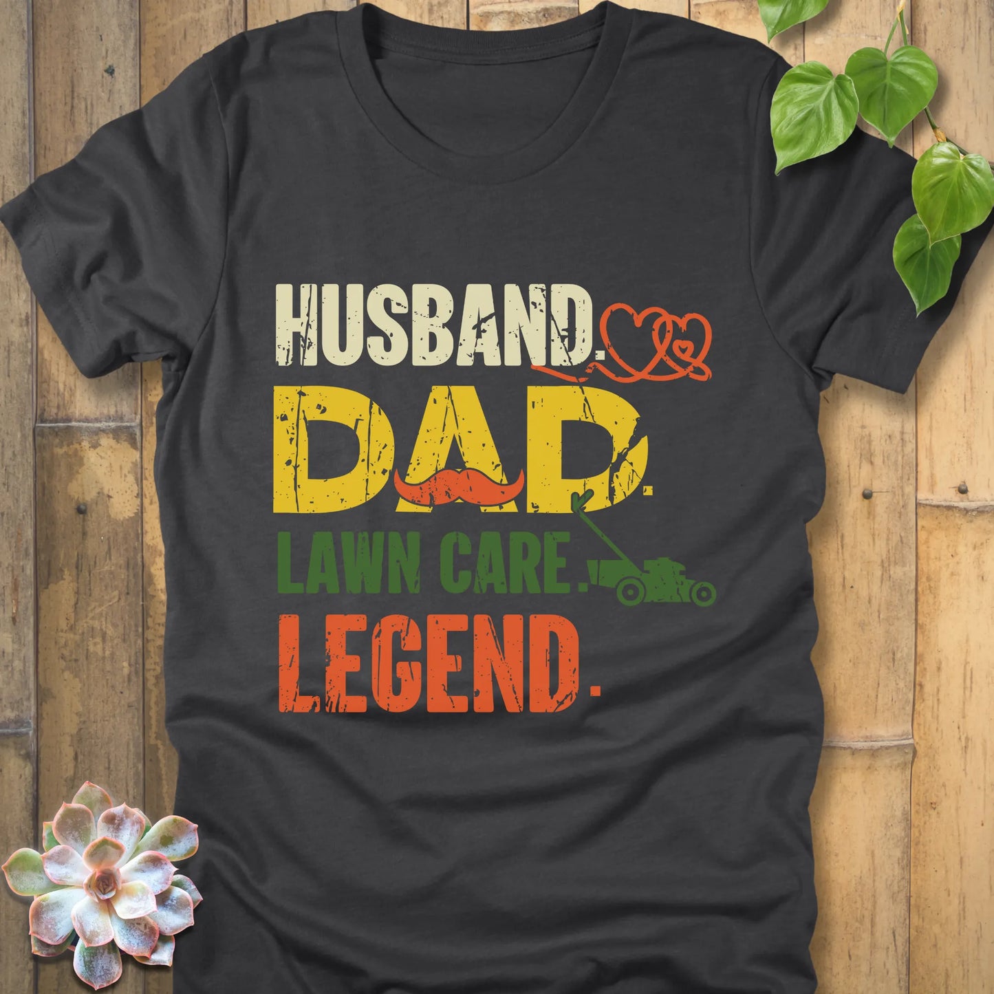 Dark Grey Heather t-shirt featuring the design "Husband, Dad lawn care legend" printed in bold letters