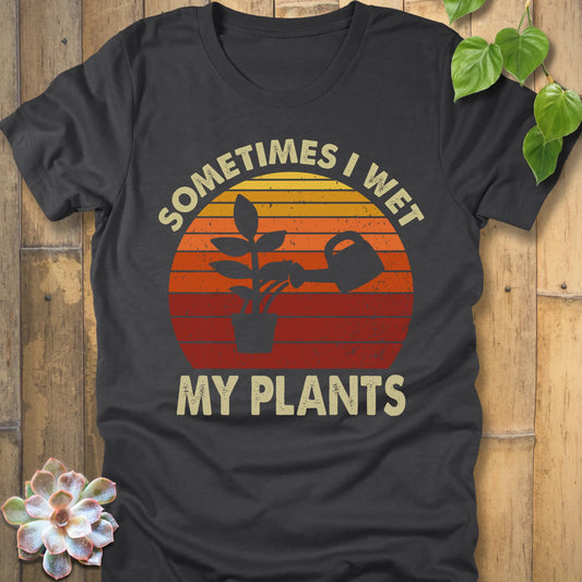Dark Grey Heather t-shirt featuring the design I Wet My Plants printed in bold letters, funny gardening shirt.