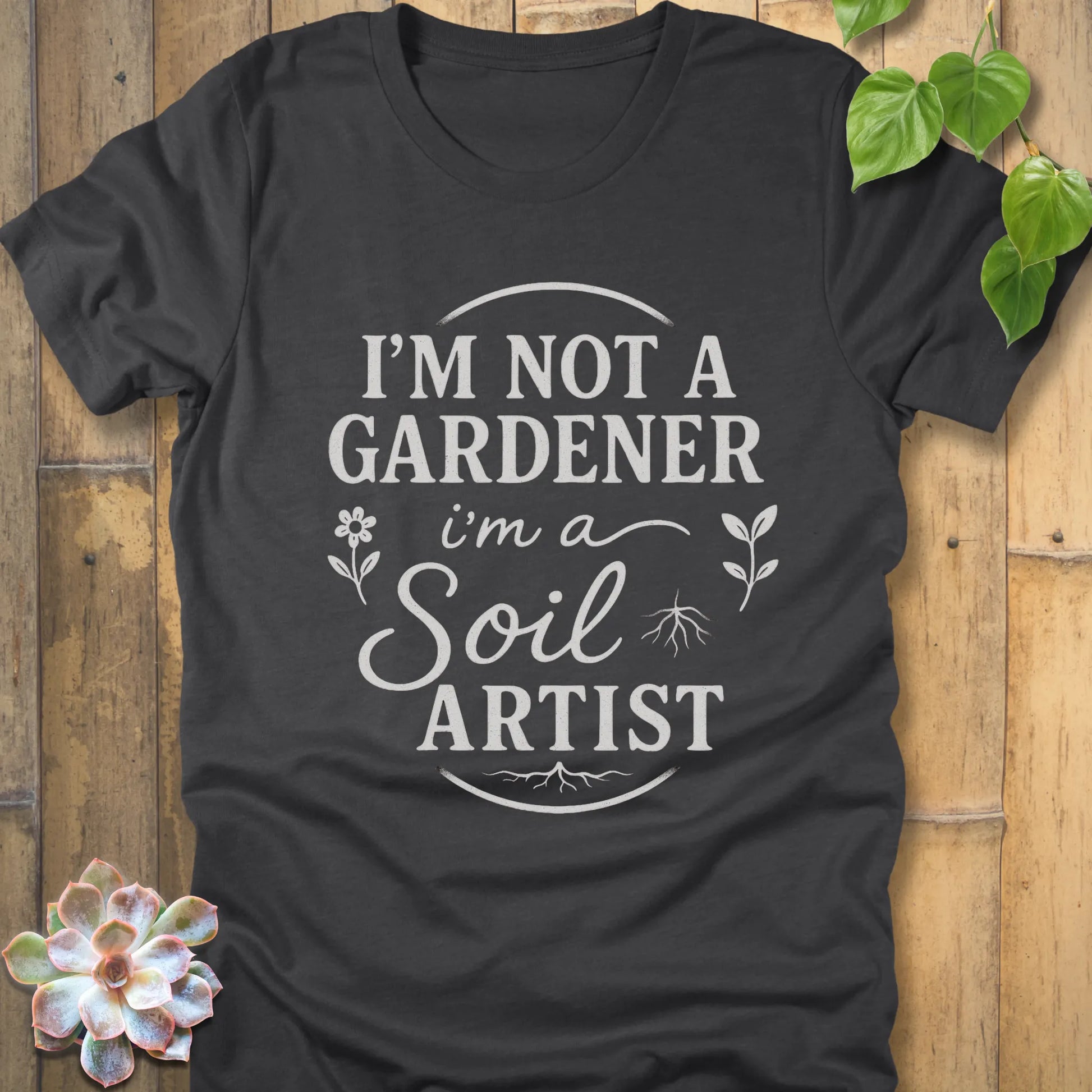 Dark Grey Heather t-shirt featuring the design I'm Not a Gardener I'm a Soil Artist printed in bold white letters