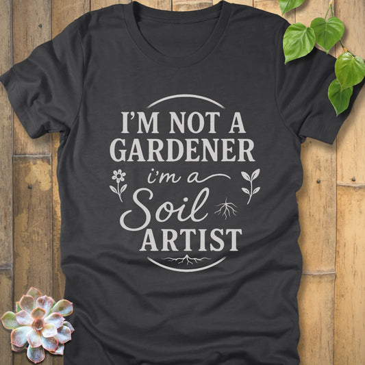 Dark Grey Heather t-shirt featuring the design I'm Not a Gardener I'm a Soil Artist printed in bold white letters