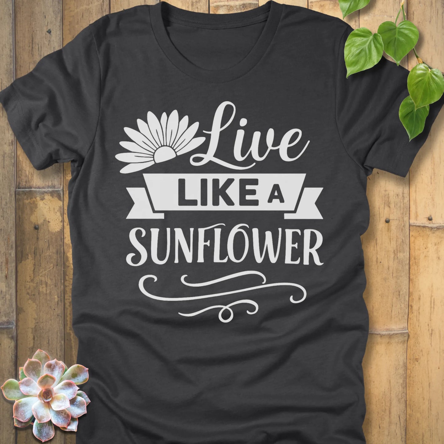Dark Grey Heather t-shirt featuring the design Live Like A Sunflower printed in bold letters, motivational gardening shirt.