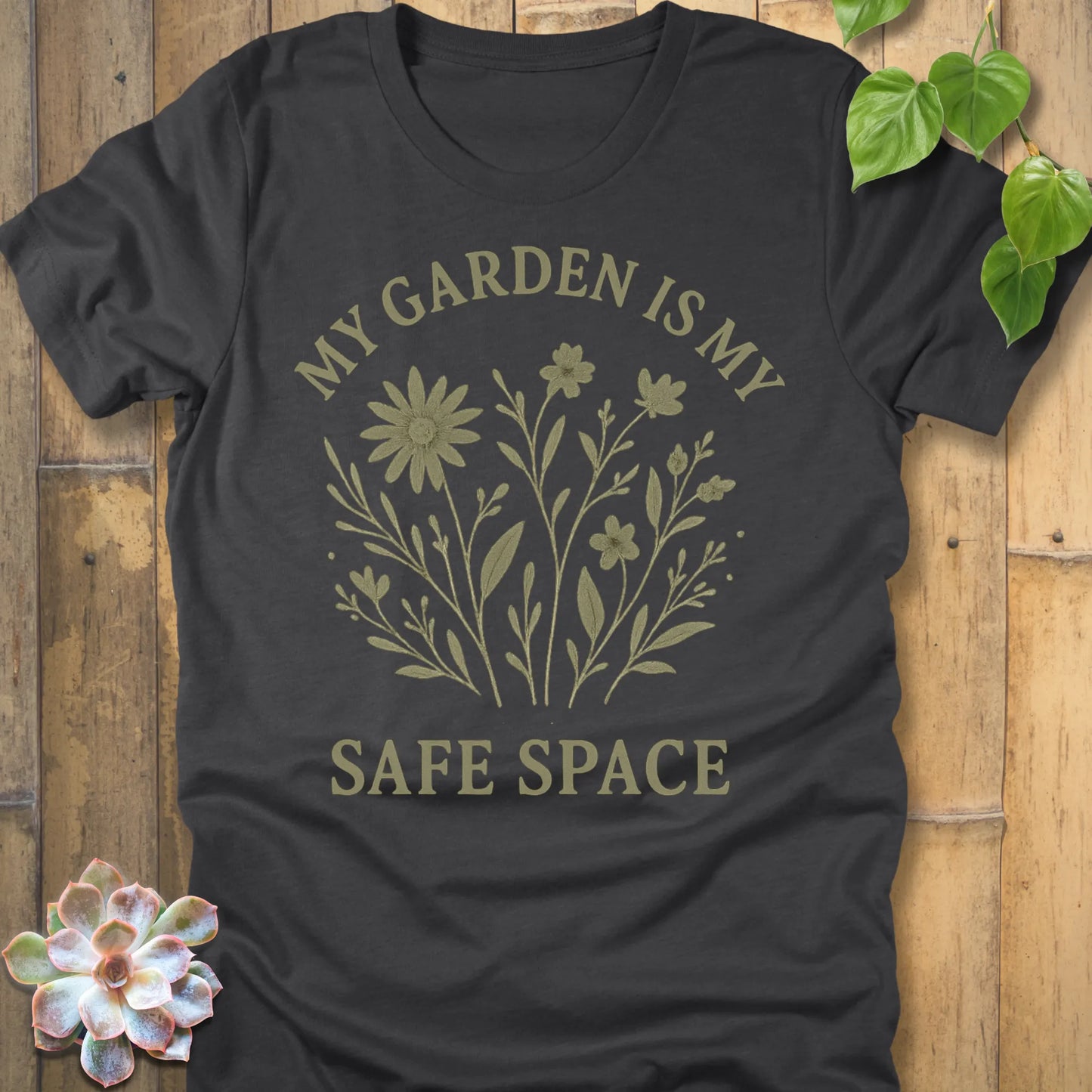Dark Grey Heather t-shirt featuring the design My Garden Is My Safe Place printed in bold letters, gardening shirt for plant lovers.