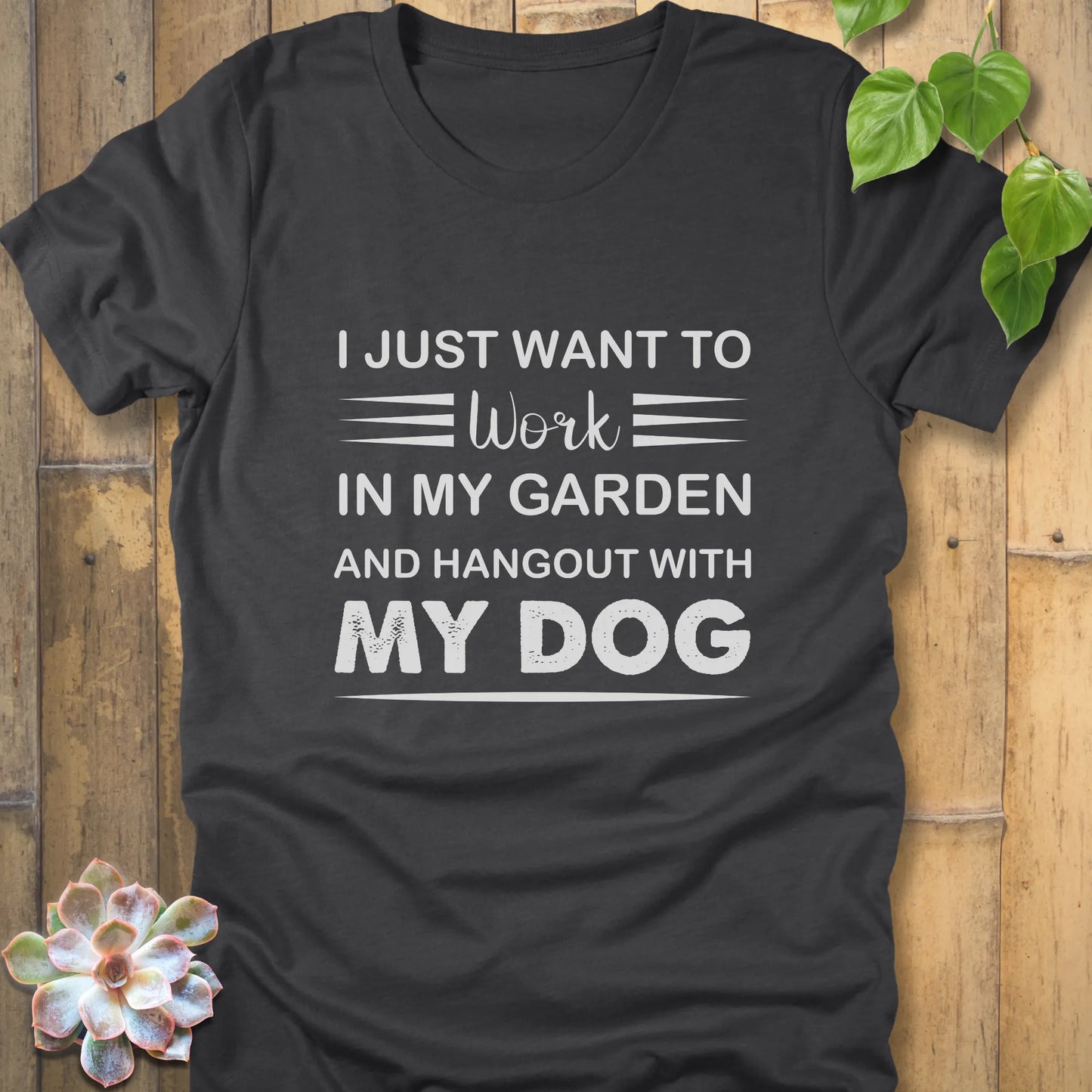 Dark grey heather t-shirt featuring the design "I just want to work in my garden and hangout with my dog" printed in white letters