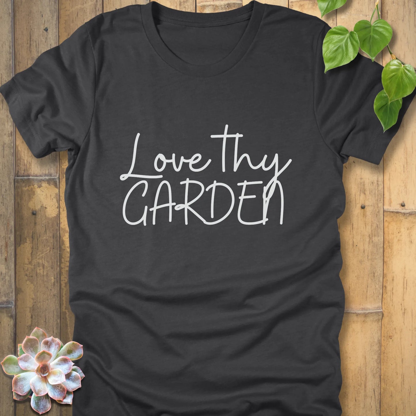 Dark grey heather t-shirt featuring the design Love Thy Garden printed in white letters
