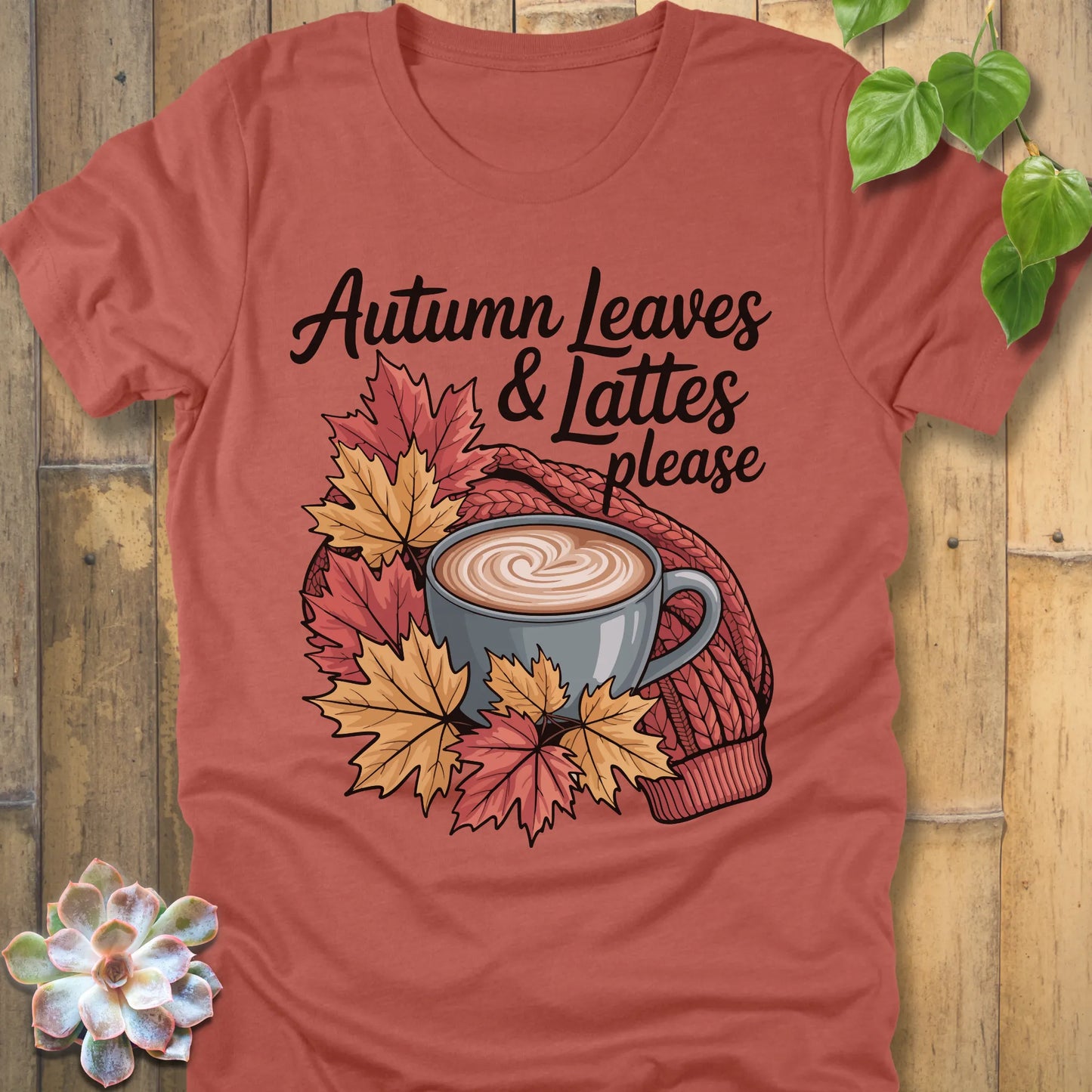 Heather Clay t-shirt featuring the design Autumn Leaves & Lattes printed in black letters with a mug of coffee and leaves