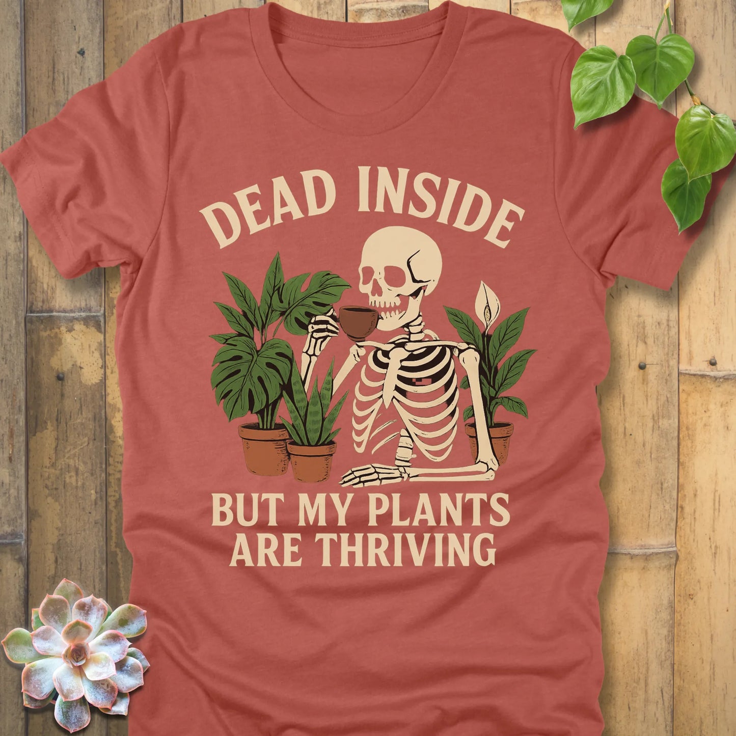 Heather Clay t-shirt featuring the design Dead Inside printed in bold letters and plants, skeleton, funny graphic tee.
