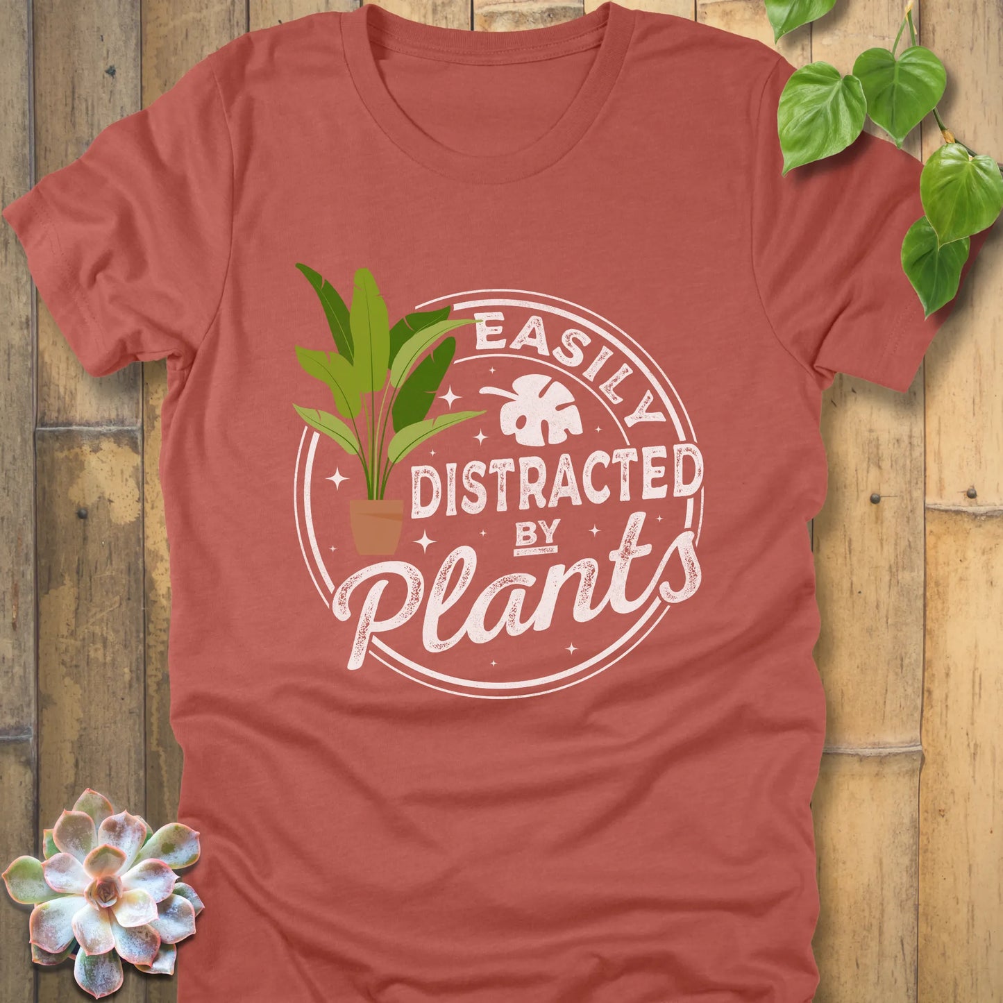 Heather Clay t-shirt featuring the design Easily Distracted by Plants with a print of a potted plant