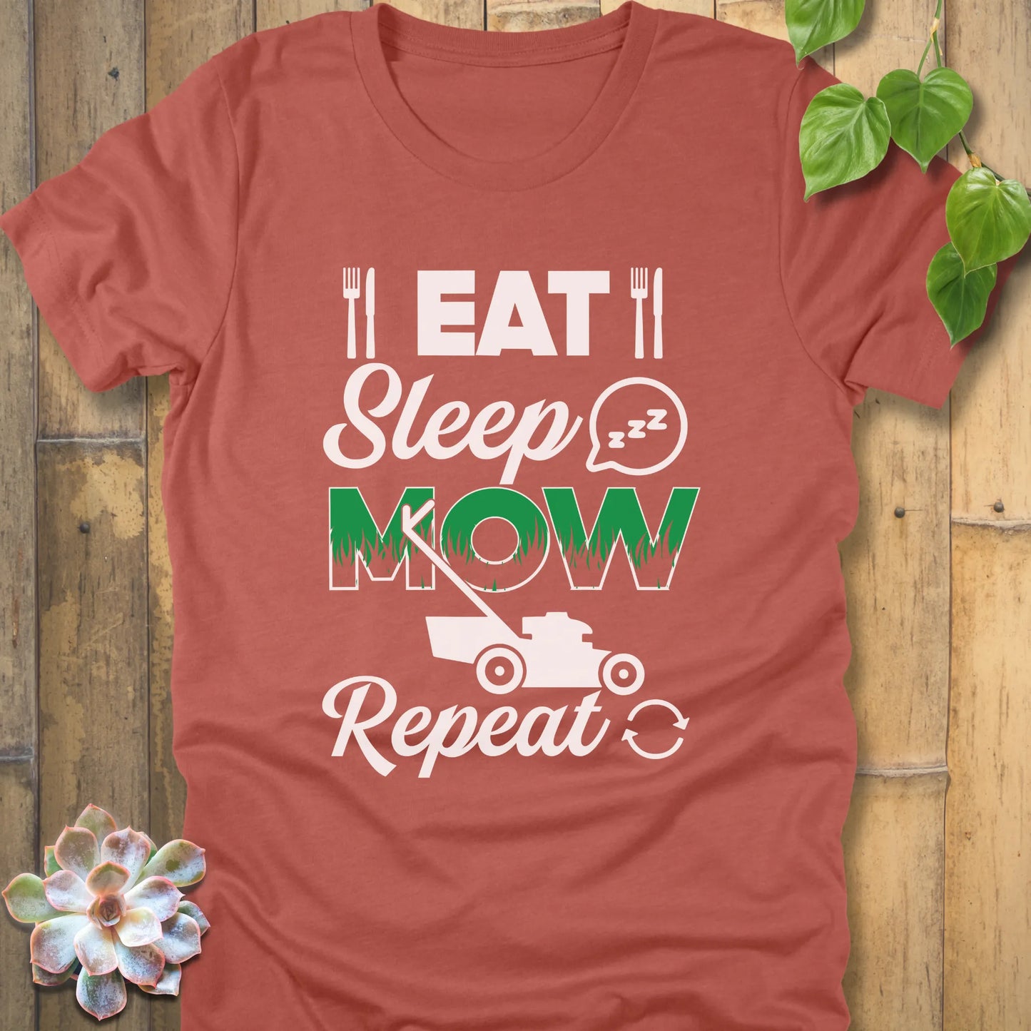 Heather Clay t-shirt featuring the design Eat, Sleep, Mow, Repeat printed with a lawn mower