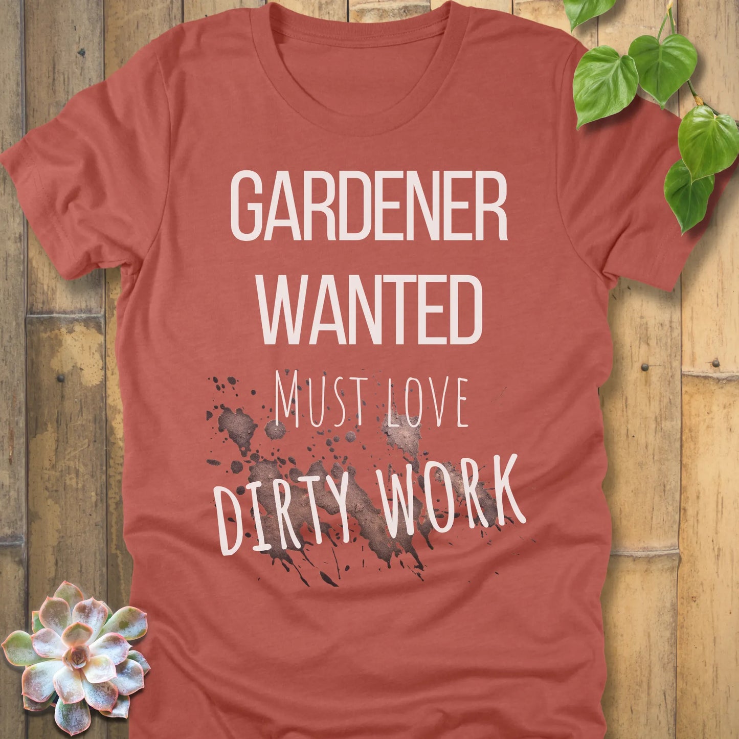 Heather Clay t-shirt featuring the design Gardener Wanted printed in bold letters, funny gardening shirt.
