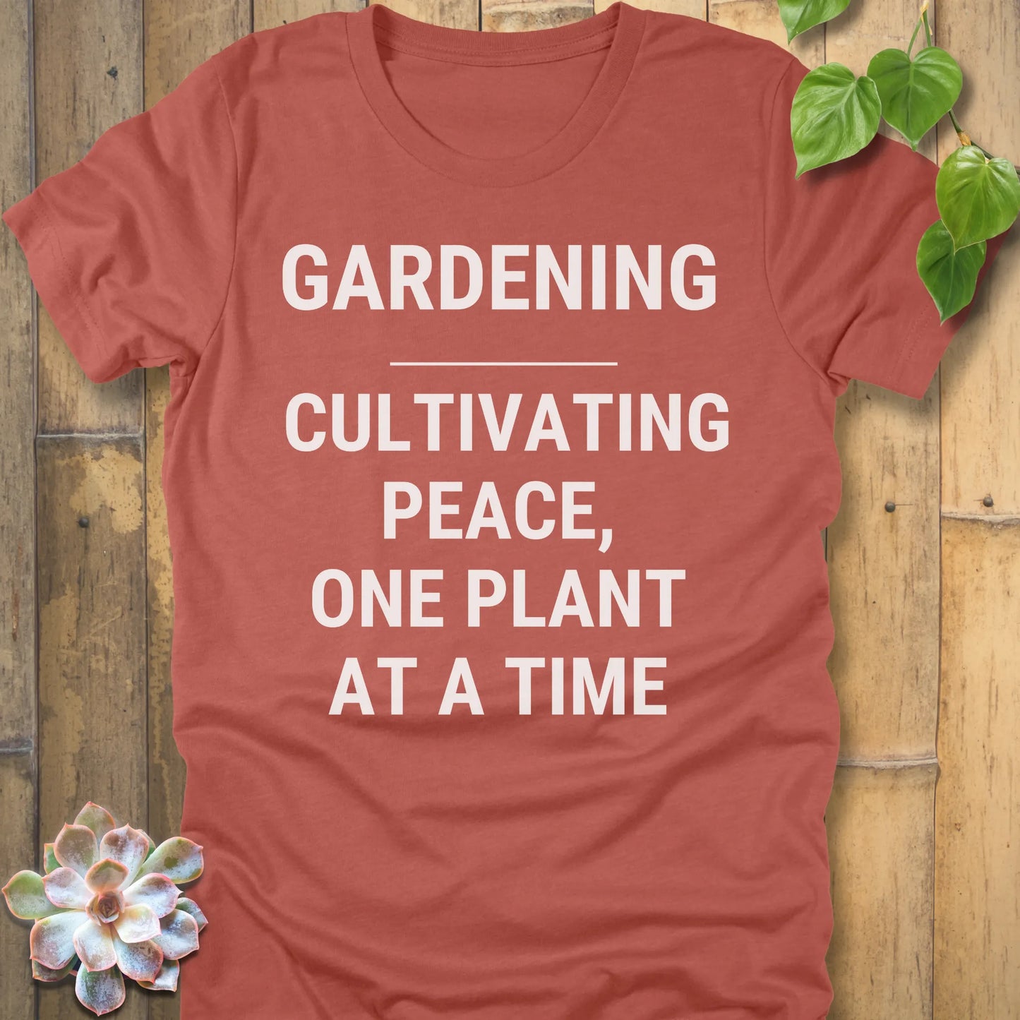 Heather Clay t-shirt featuring the design Gardening Cultivating Peace, One Plant At A Time printed in bold white letters, funny gardening shirt.