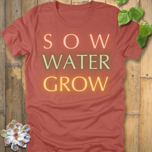 Heather Clay t-shirt featuring the design Grow Dammit printed in bold letters, funny gardening shirt.