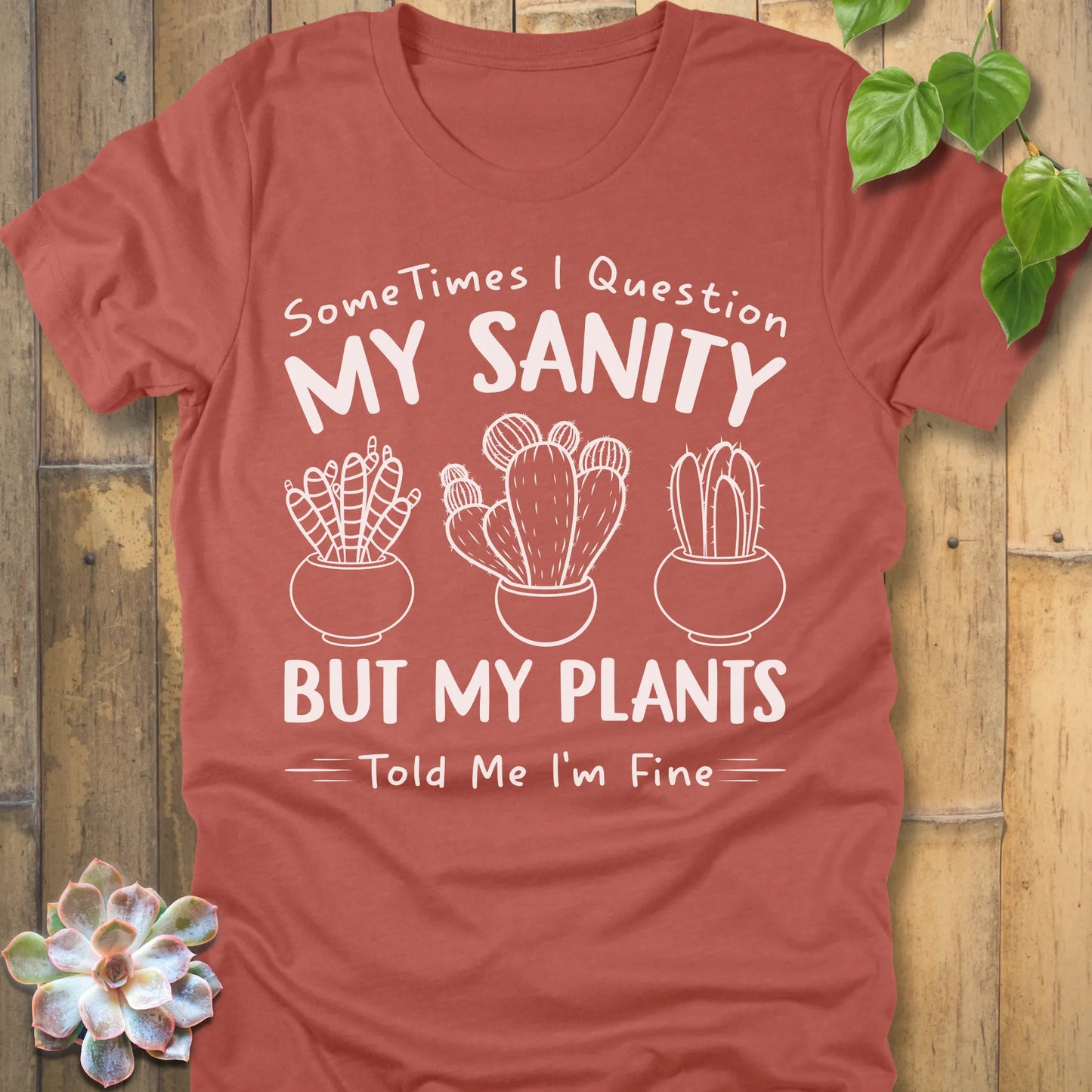 Heather Clay t-shirt featuring the design I'm Fine printed in bold white letters, ang plants