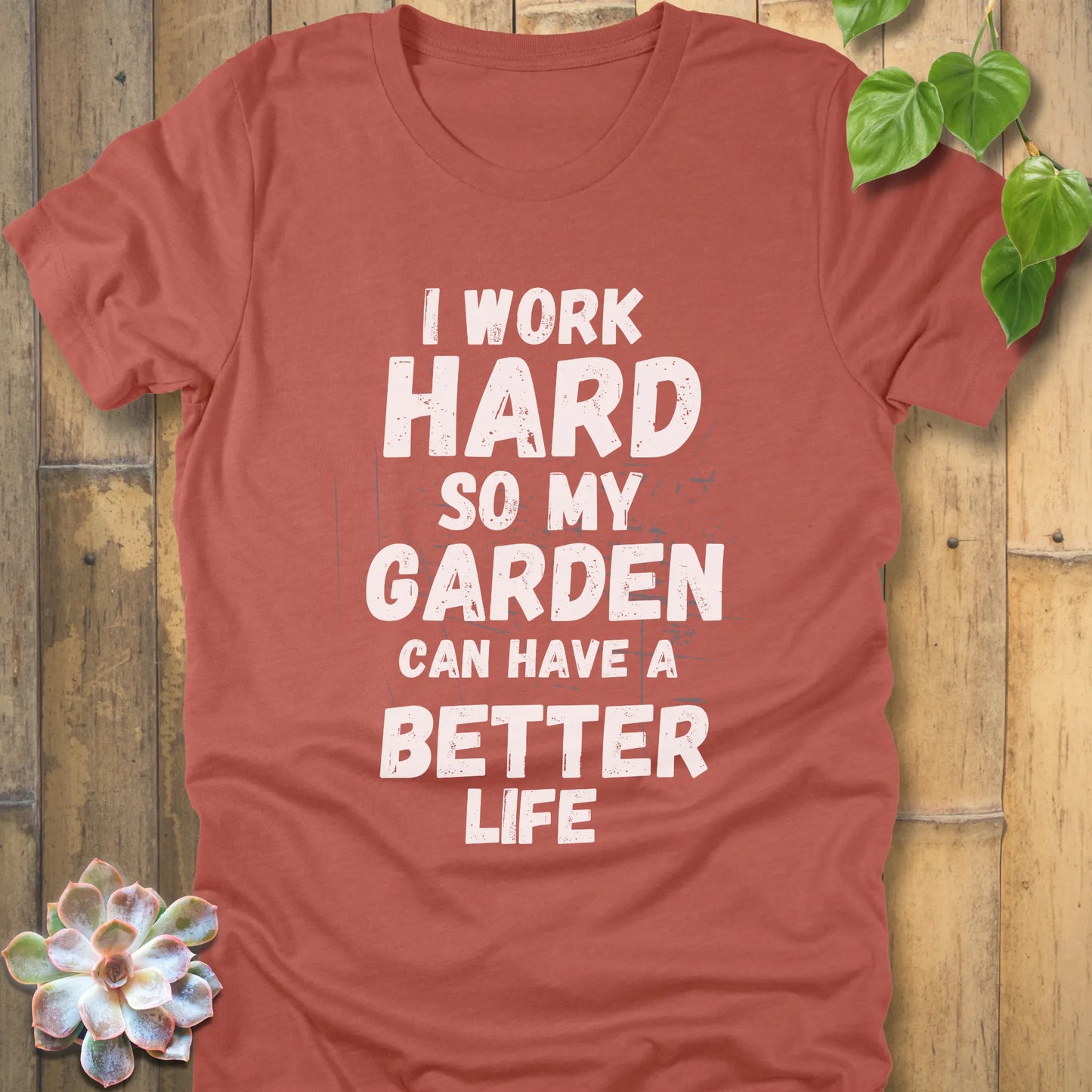 Heather Clay t-shirt featuring the design I work hard so my garden can have a better life in bold lettering.