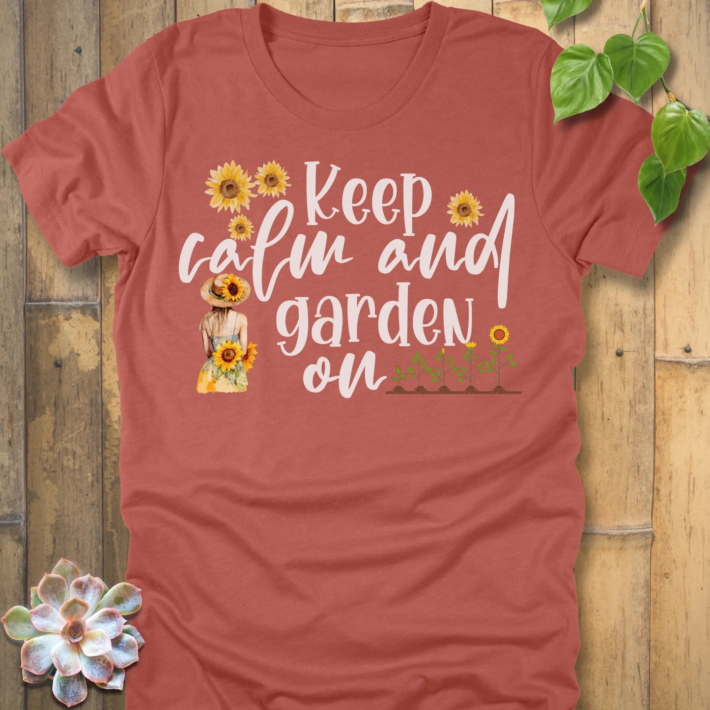 Heather Clay t-shirt featuring the design Keep Calm printed in white letters and sunflowers