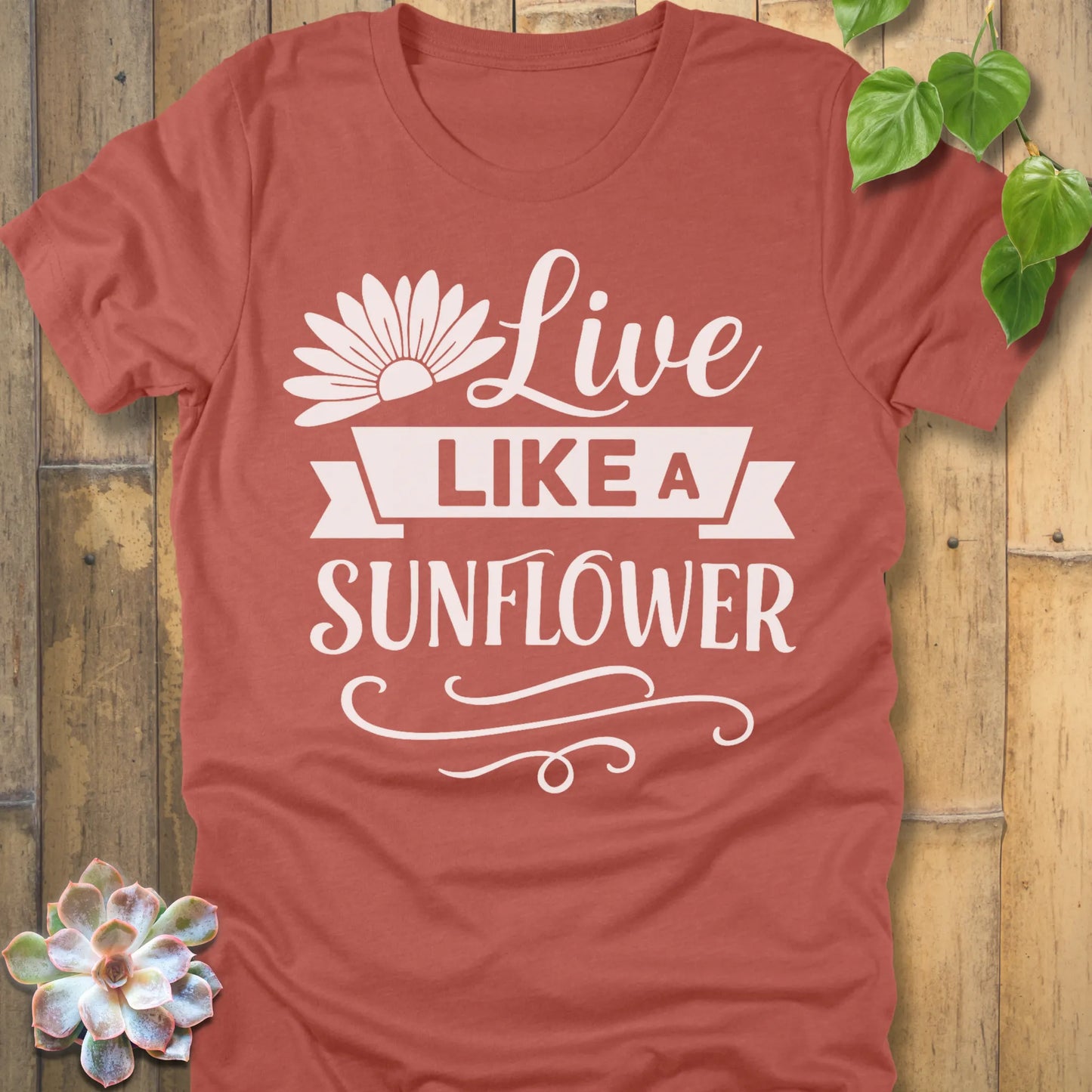 Heather Clay t-shirt featuring the design Live Like A Sunflower printed in bold letters, motivational gardening shirt.