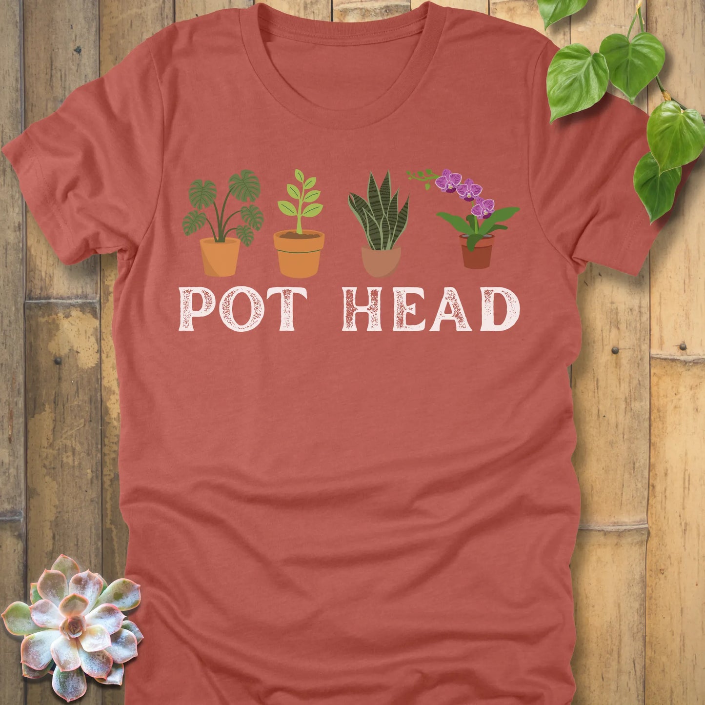 Heather Clay t-shirt featuring the design Pot Head printed in bold letters and plants in the pots, funny gardening shirt.