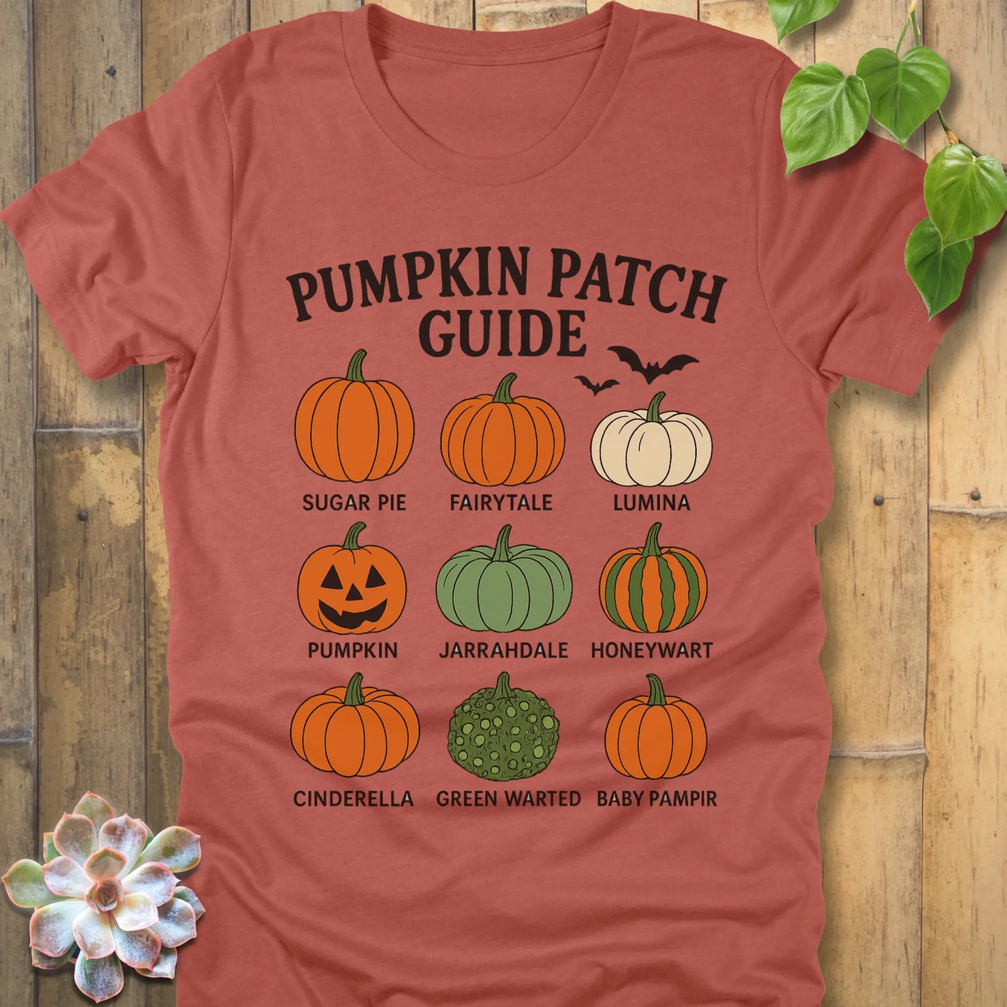 Heather Clay t-shirt featuring the design Pumpkin Patch Guide printed in bold black letters and pumpkin