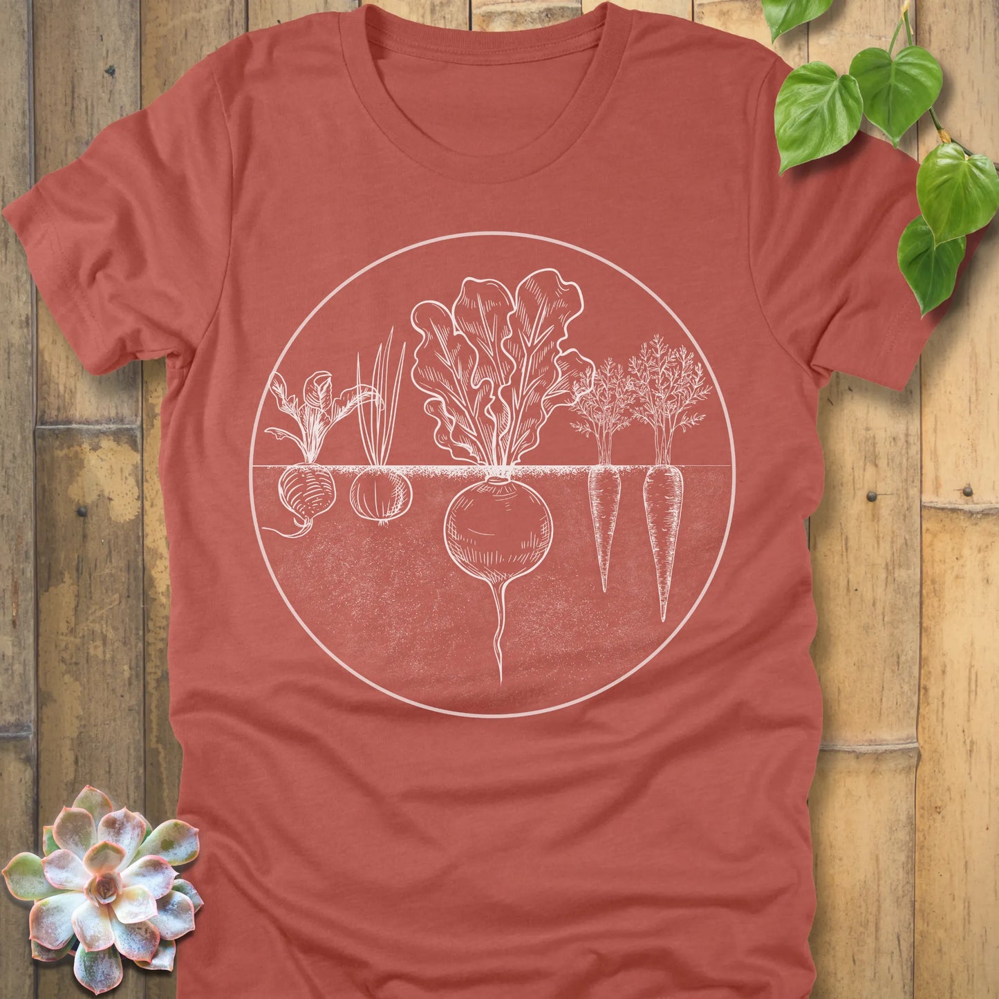 Heather Clay t-shirt featuring the design Rooted Vegetables printed in white design, organic vegetable shirt.