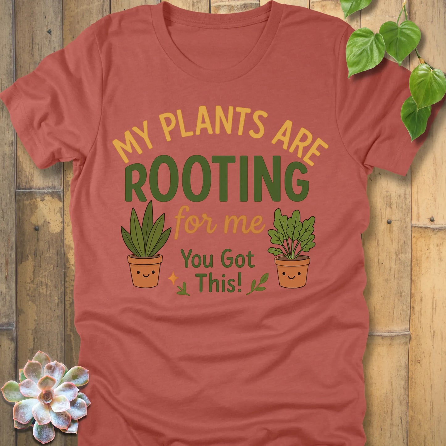 Heather Clay t-shirt featuring the design Rooting For Me printed in bold letters and plants, gardening graphic tee.
