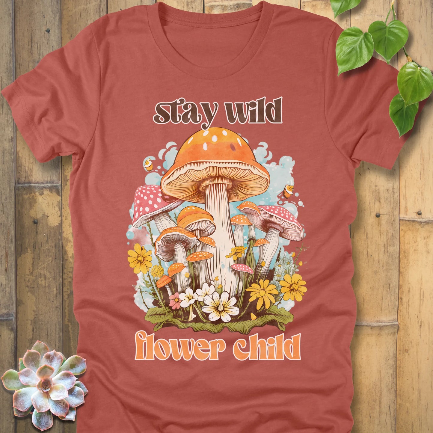 Heather Clay t-shirt featuring the design Stay Wild Flower printed in bold letters, floral graphic tee.