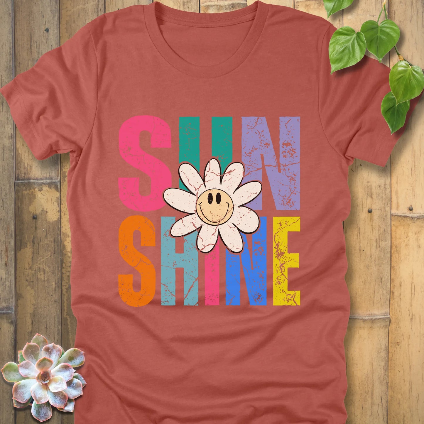 Heather Clay t-shirt featuring the design Sunshine printed in colourful letters and a sunflower