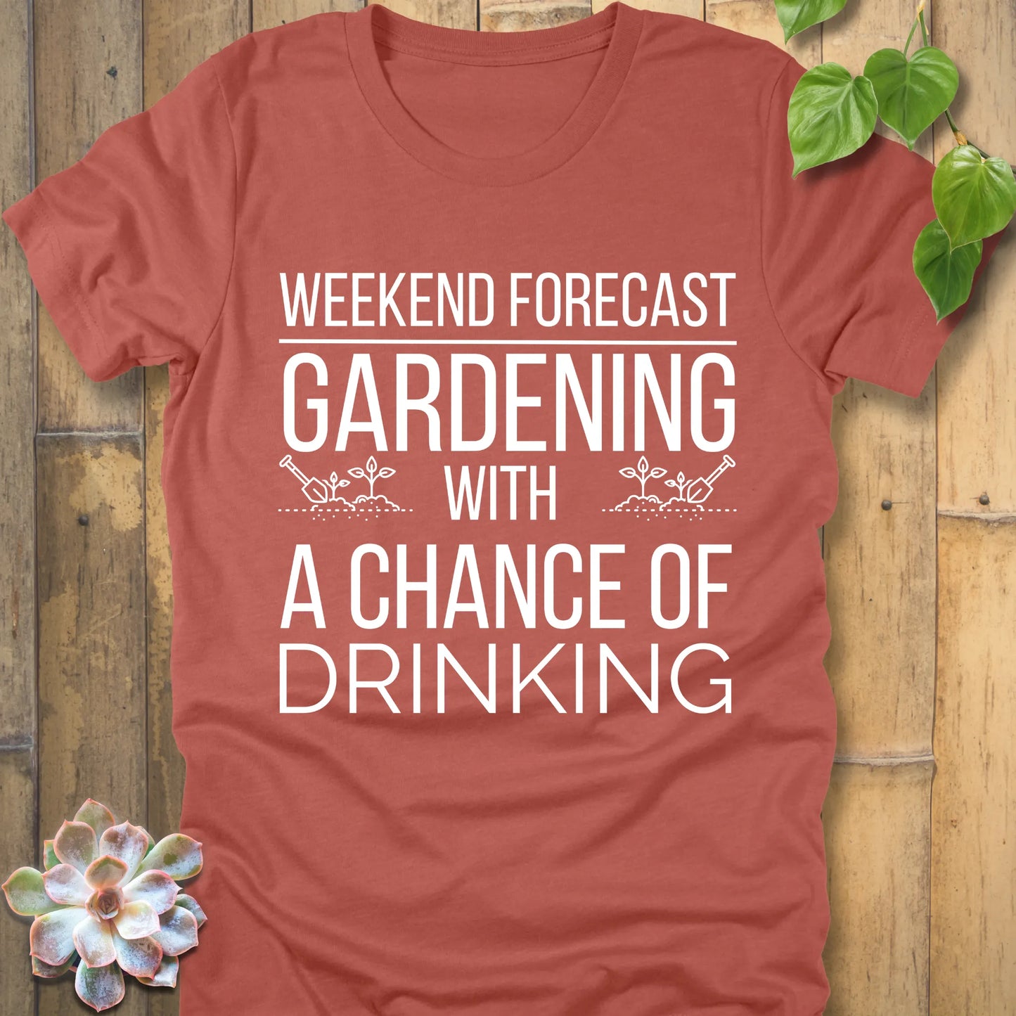 Heather Clay t-shirt featuring the design "Weekend forecast gardening with a chance of drinking" in bold letters, gardening gift tee.