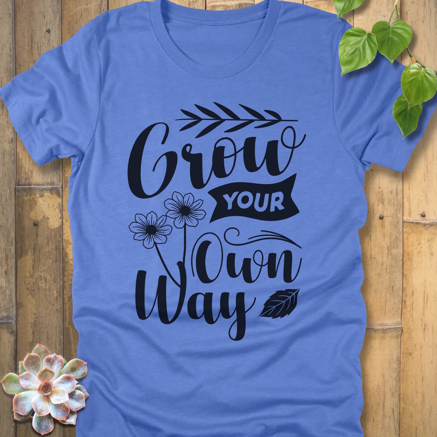 Heather Colombia Blue cotton graphic t-shirt featuring the inspirational phrase Grow your own way, stylish casual wear.