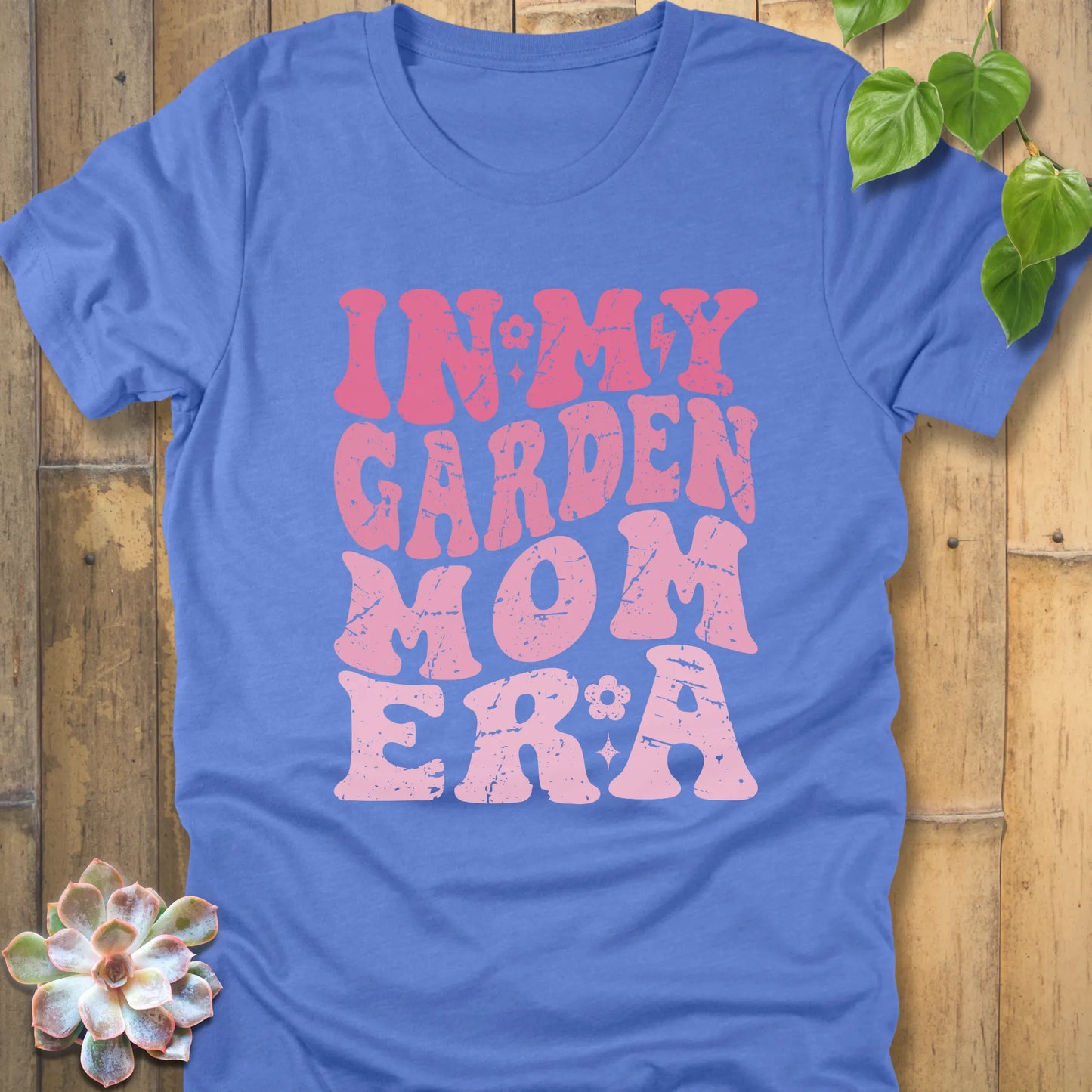Heather Colombia Blue t-shirt featuring the design In My Garden Mom Era printed in bold pink letters, chic outdoor gardening wear.