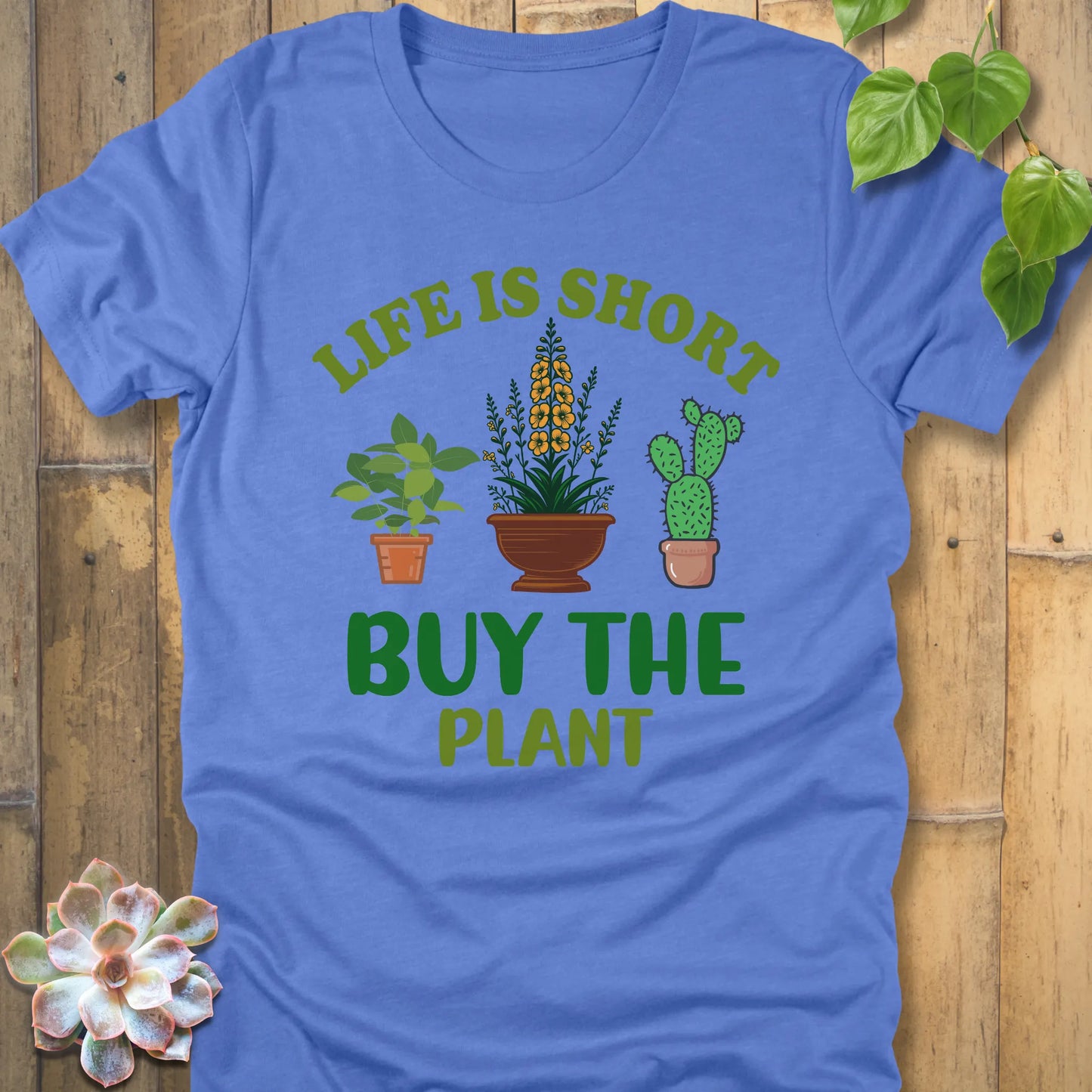 Heather Colombia Blue t-shirt featuring the design Life is short, buy the plant printed in green text with plant illustration