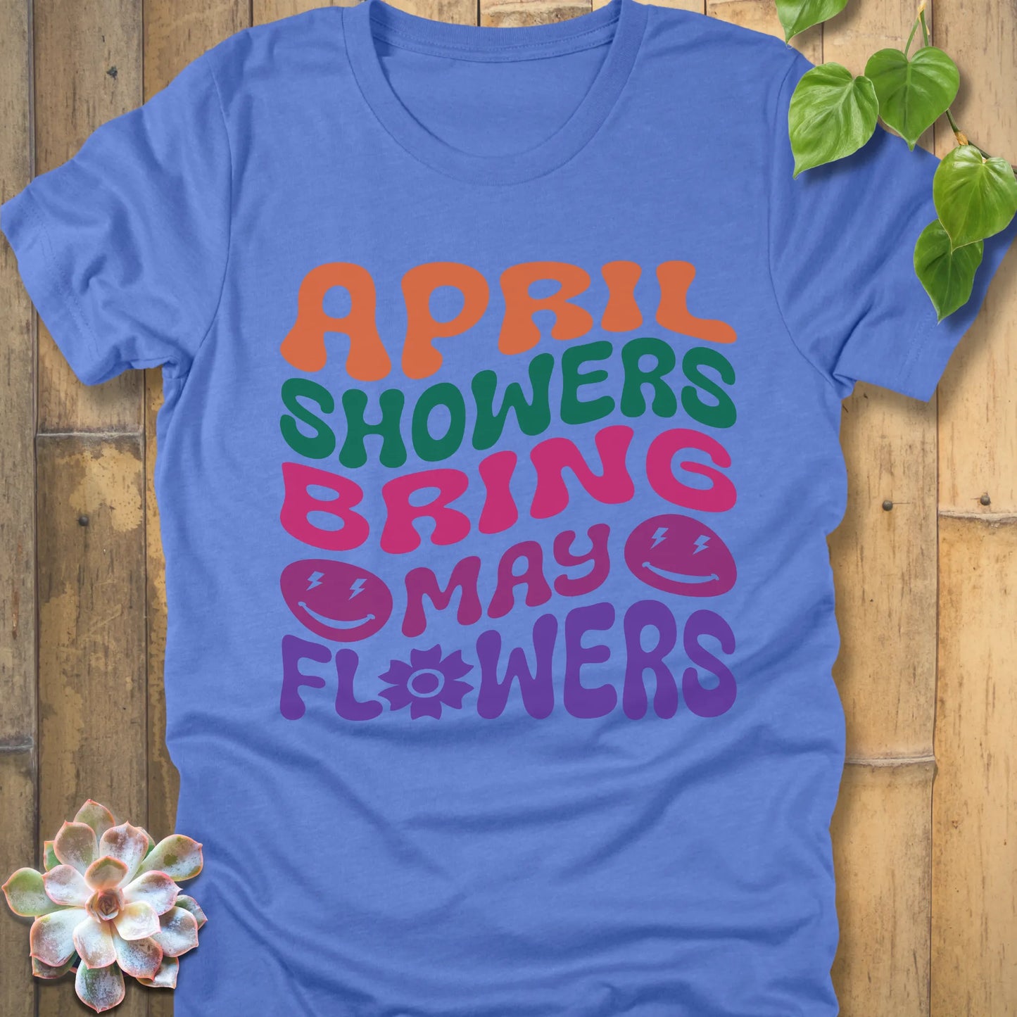 Heather Columbia Blue t-shirt featuring the design April Shower printed in bold colorful letters, casual gardening shirt.