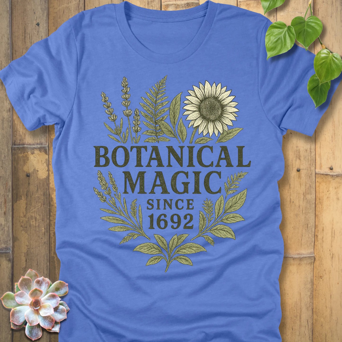 Heather Columbia Blue t-shirt featuring the design Botanical Magic printed in bold letters, botanical garden shirt.