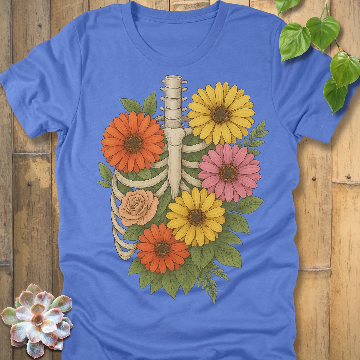 Heather Columbia Blue t-shirt featuring the design Gerbera Bones halloween floral skeleton graphic tee.