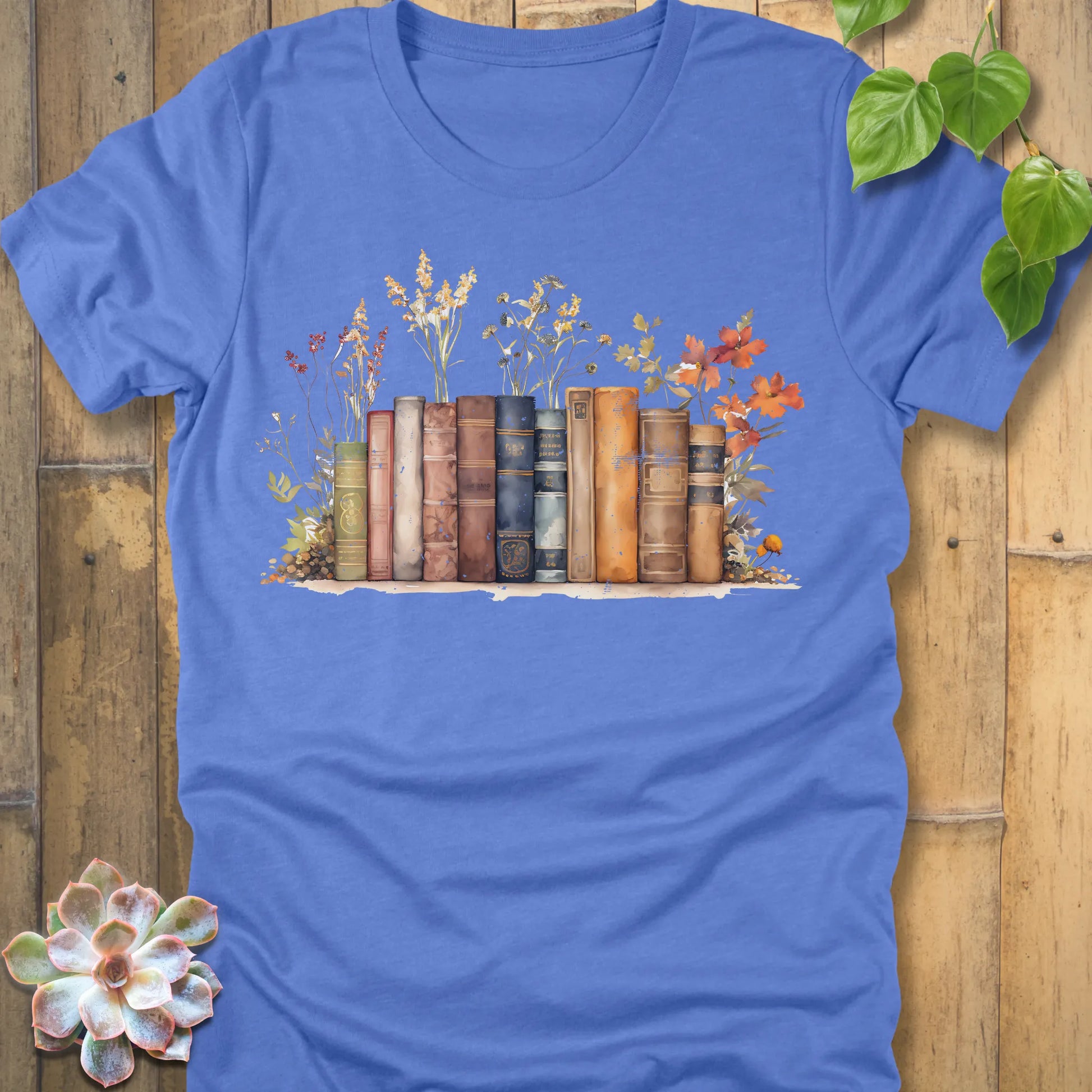 Heather Columbia Blue t-shirt featuring the design Wildflower Library printed with books and plants, floral graphic tee for plant lovers.