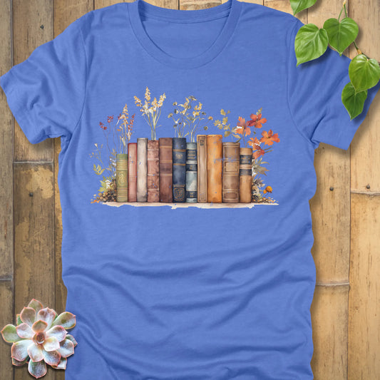 Heather Columbia Blue t-shirt featuring the design Wildflower Library printed with books and plants, floral graphic tee for plant lovers.