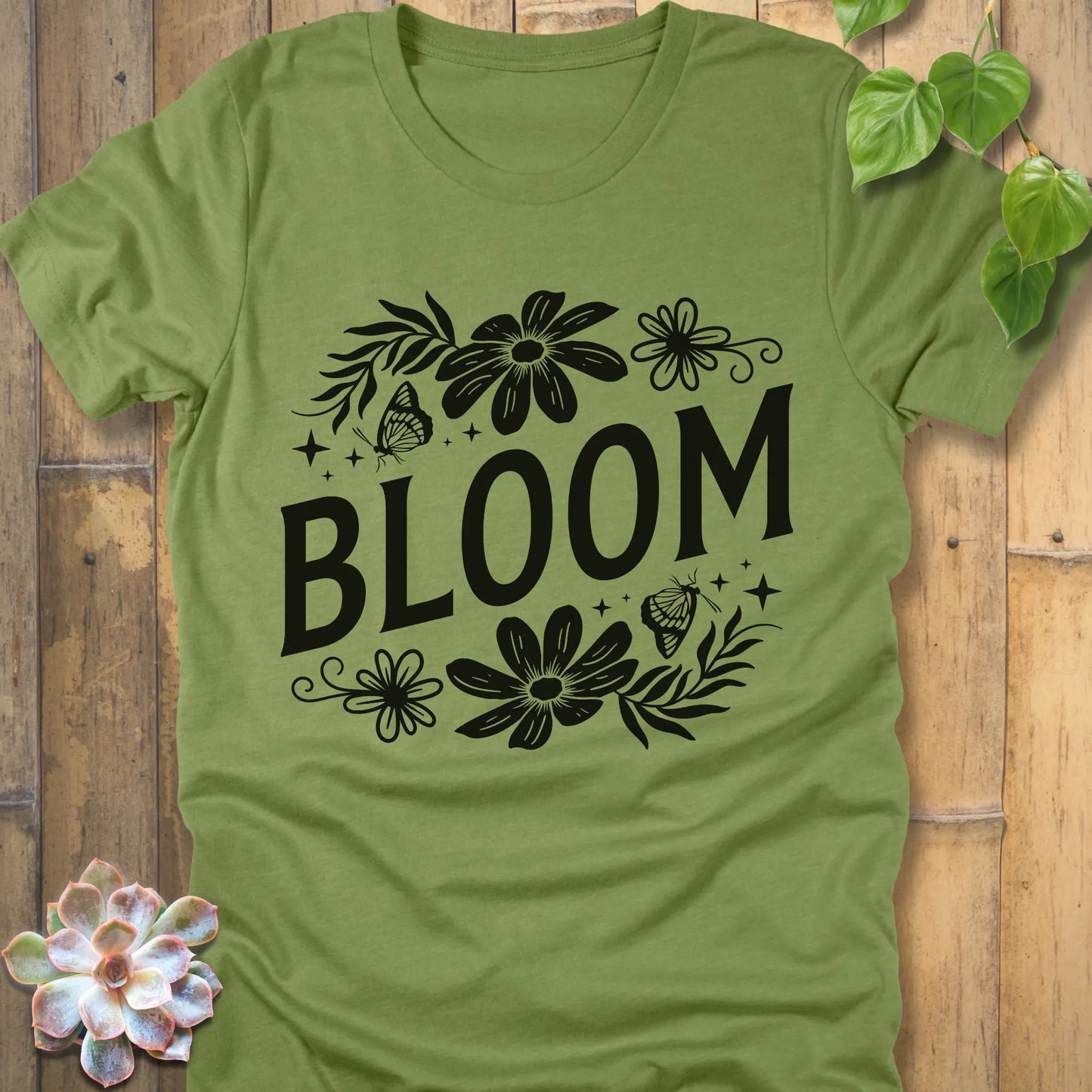 Heather Green t-shirt featuring the design " Bloom " printed in bold black letters with flowers