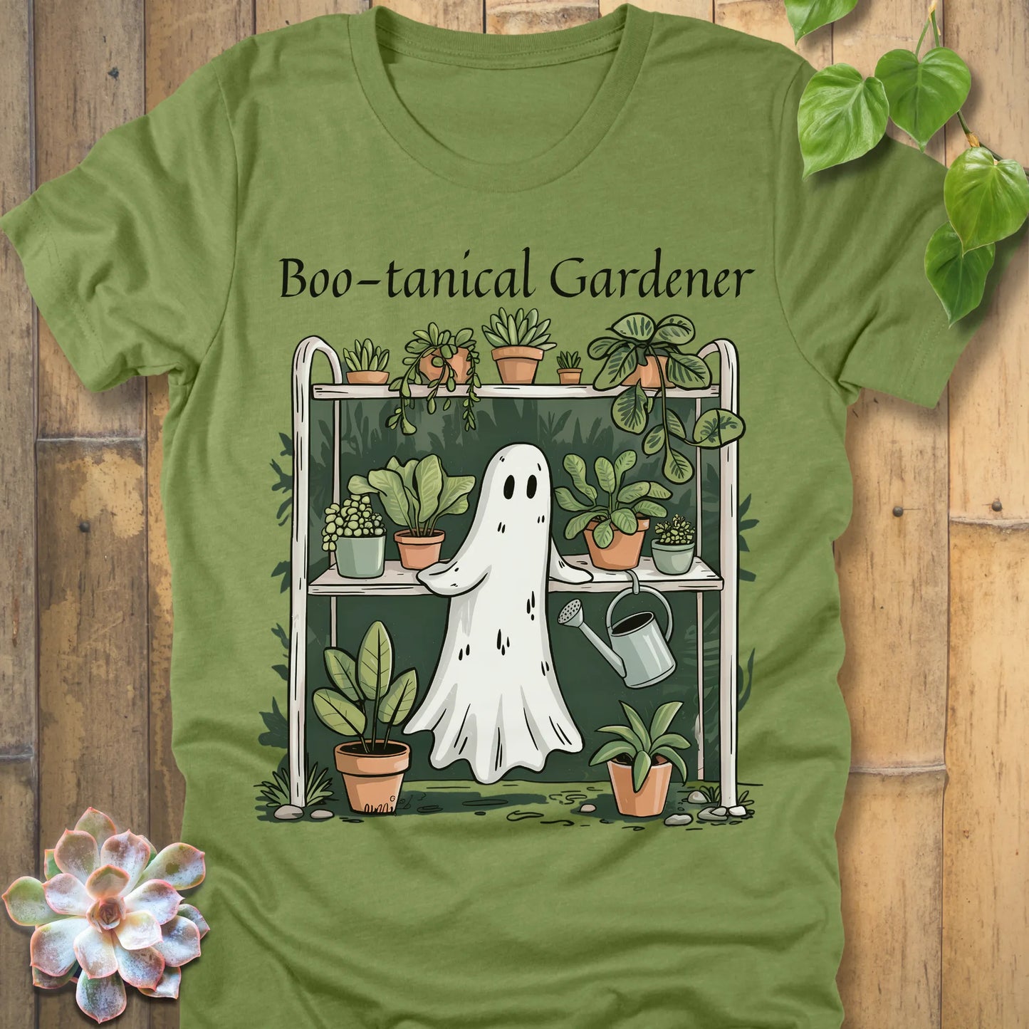 Heather Green t-shirt featuring the design Boo – tanical Gardener printed in black letters and a ghost in garden