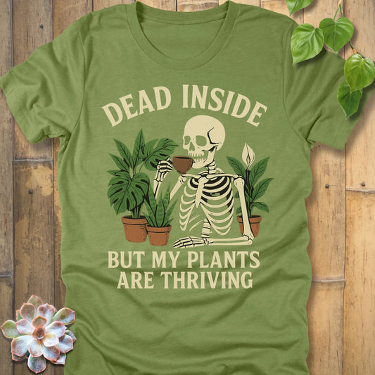 Heather Green t-shirt featuring the design Dead Inside printed in bold letters and plants, skeleton, funny graphic tee.