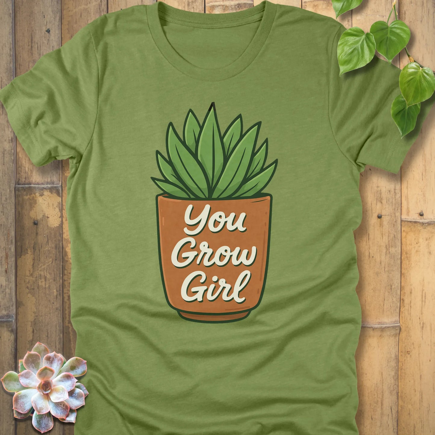 Heather Green t-shirt featuring the design Grow Girl printed in bold letters and plant in the pot, casual plant lover shirt.
