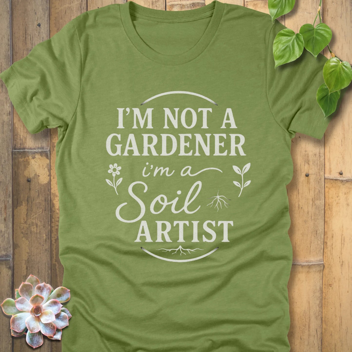 Heather Green t-shirt featuring the design I'm Not a Gardener I'm a Soil Artist printed in bold white letters