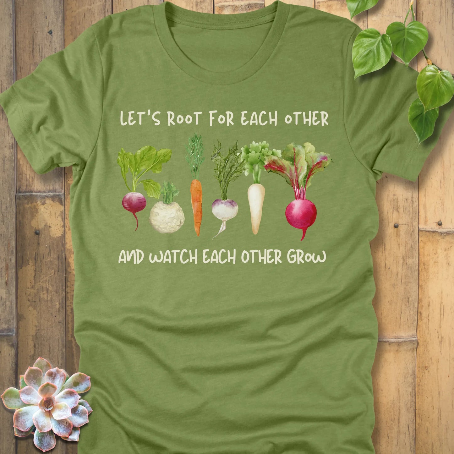Heather Green t-shirt featuring the design Let’s Root printed in bold letters and a vegetables, casual gardening shirt.