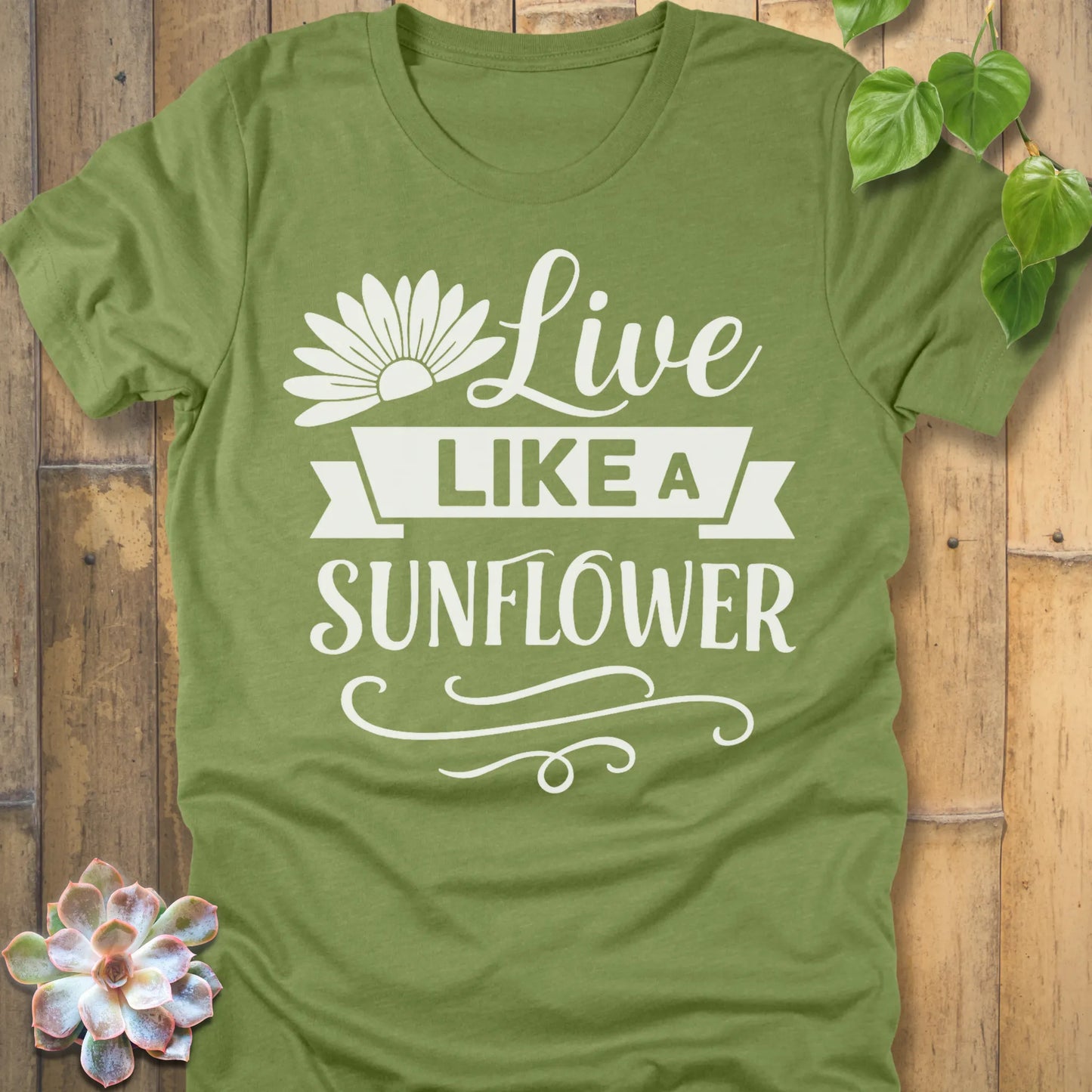 Heather Green t-shirt featuring the design Live Like A Sunflower printed in bold letters, motivational gardening shirt.