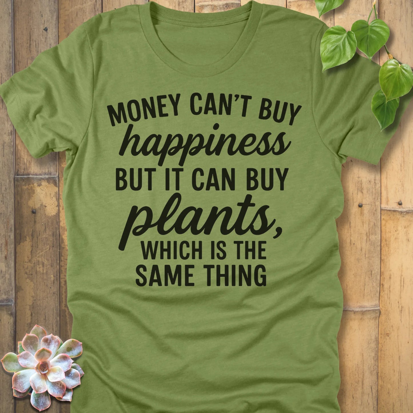 Heather Green t-shirt featuring the design Money Can’t Buy Happiness printed in bold black letters, motivational quote shirt.