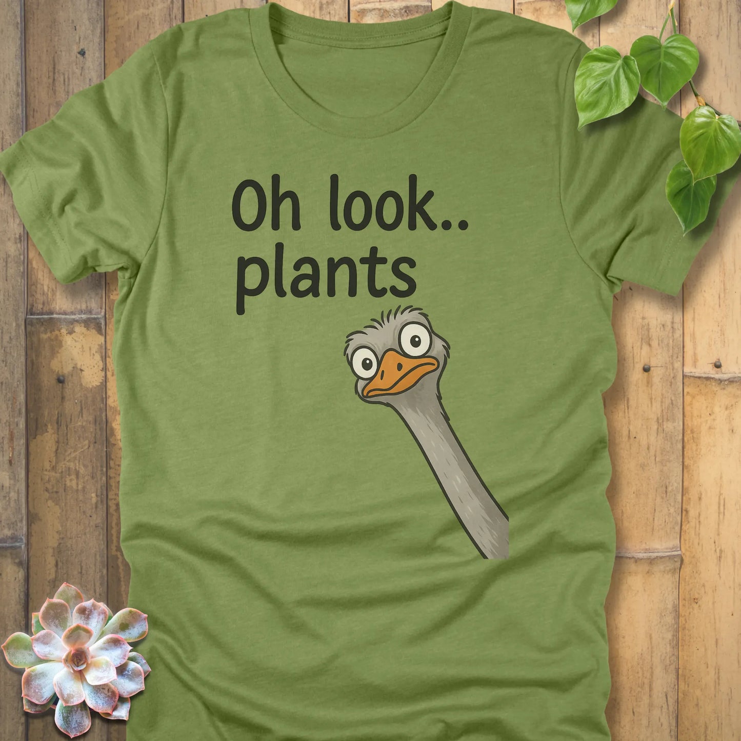 Heather Green t-shirt featuring the design Oh Look Plants printed in black letters, with animal.
