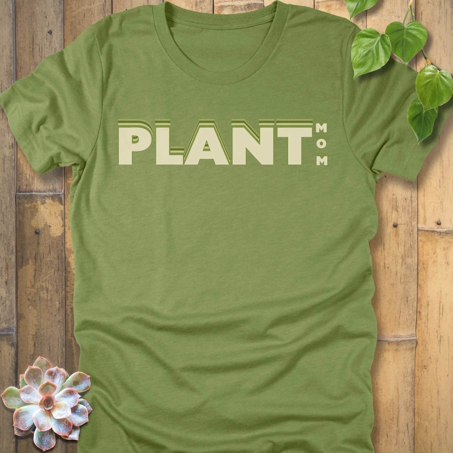 Heather Green t-shirt featuring the design Plant Mom printed in bold green letters