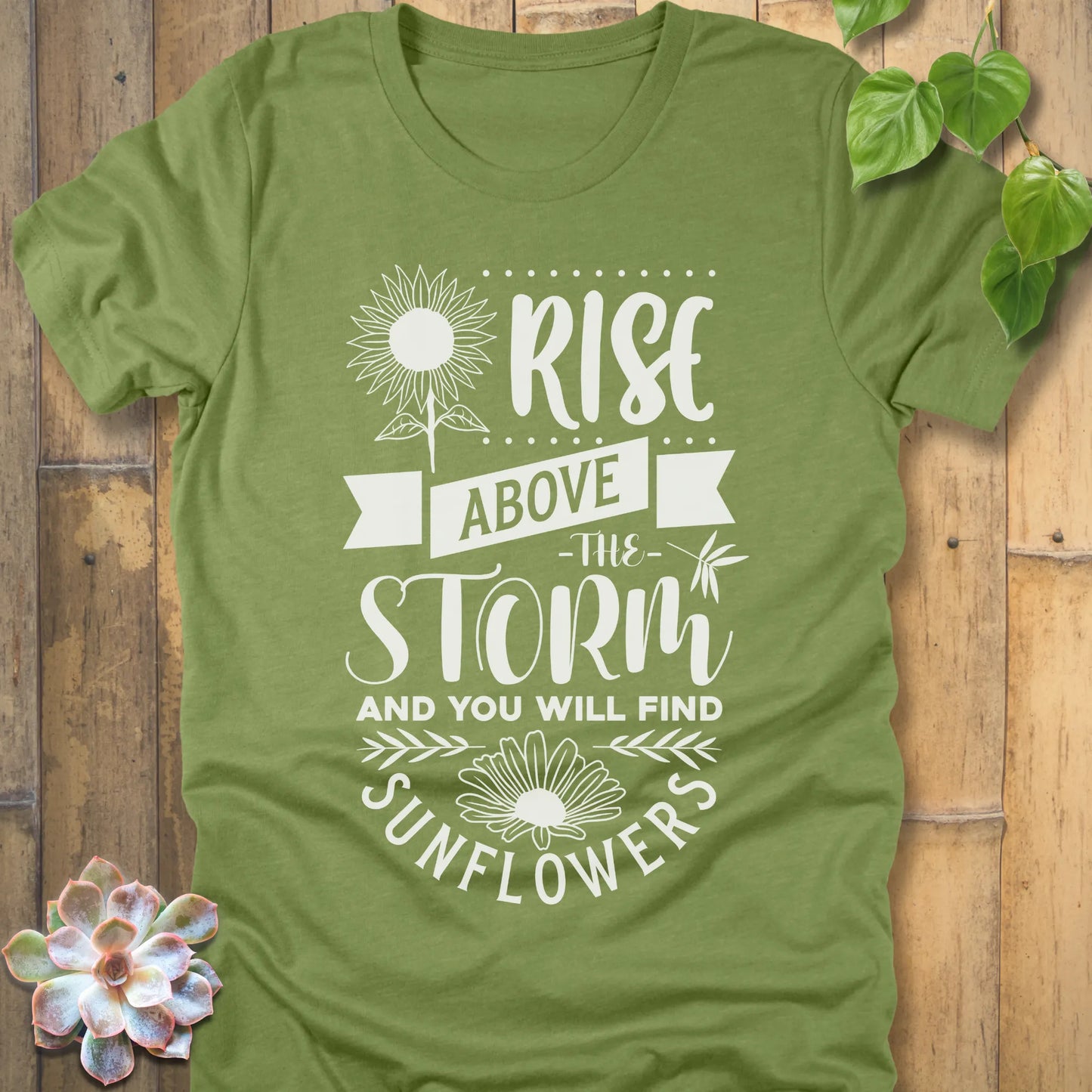 Heather Green t-shirt featuring the design Rise above the storm and you will find sunflowers printed in white letters